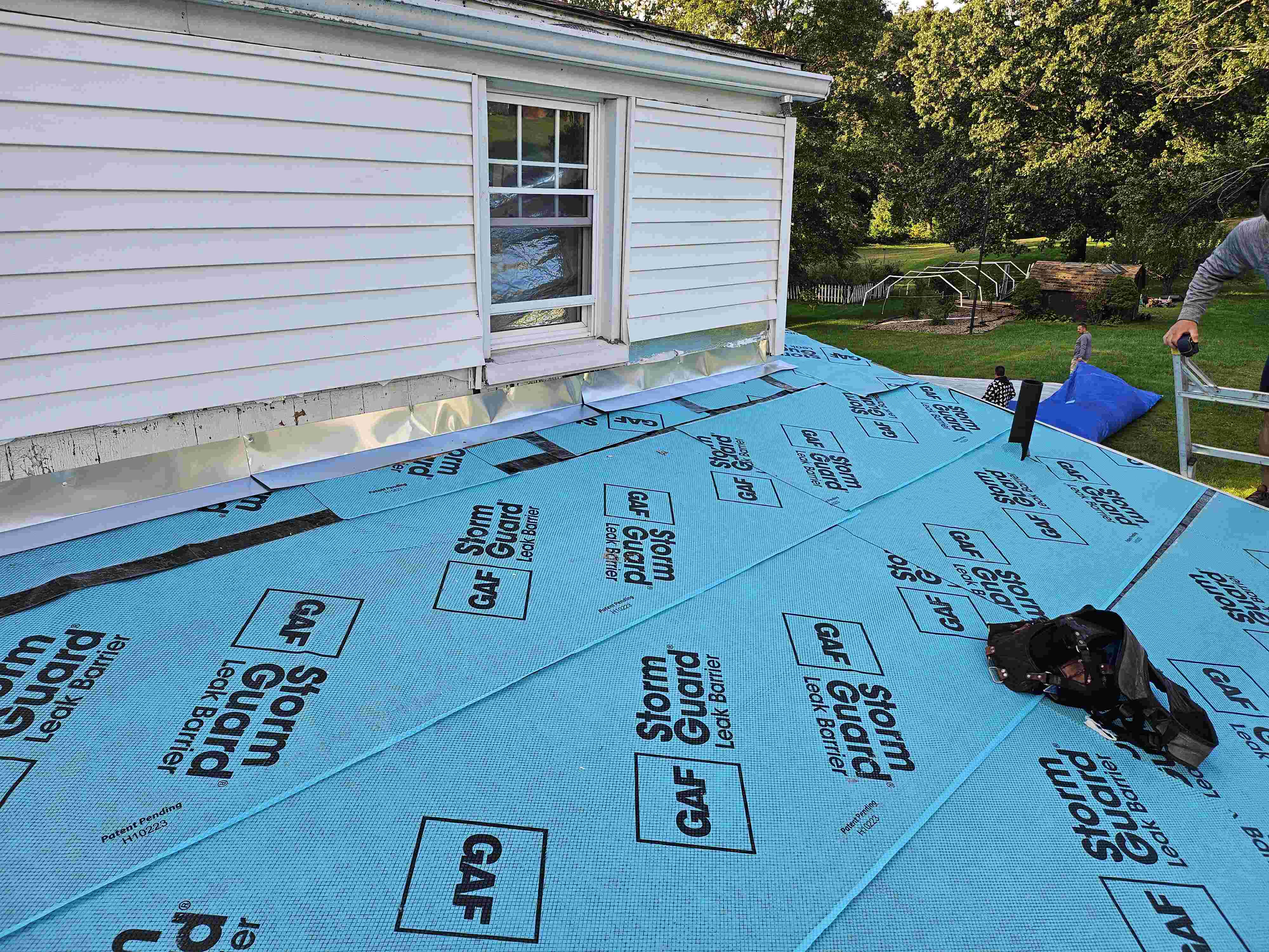 workers ripping roof