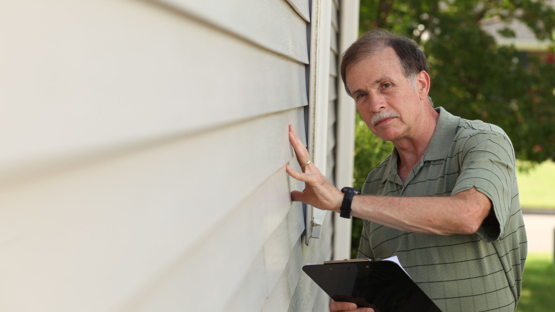 inspection of new vinyl siding installation