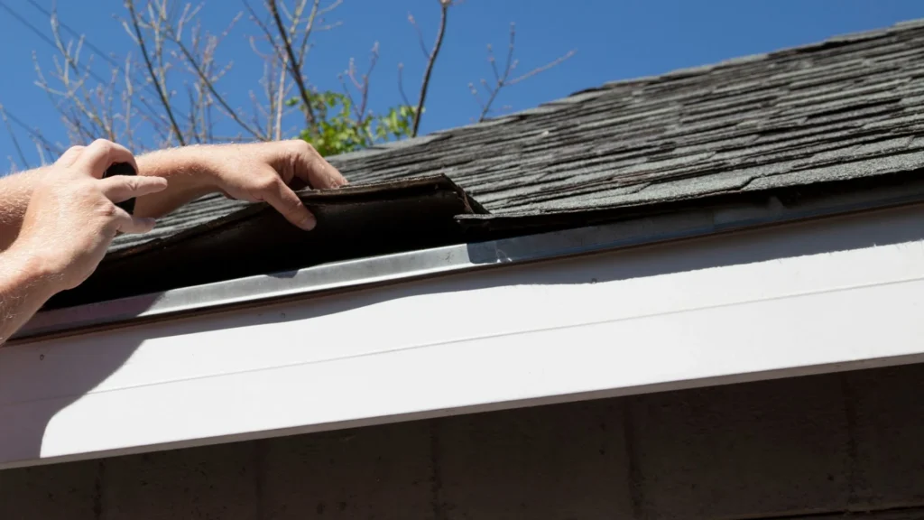 roofer inspecting shingles on a ladder, Newington CT area