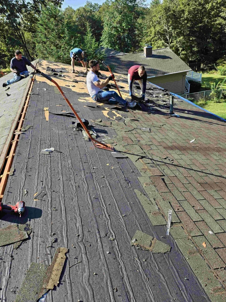 roofing crew tearing off old shingles, New Britain CT area