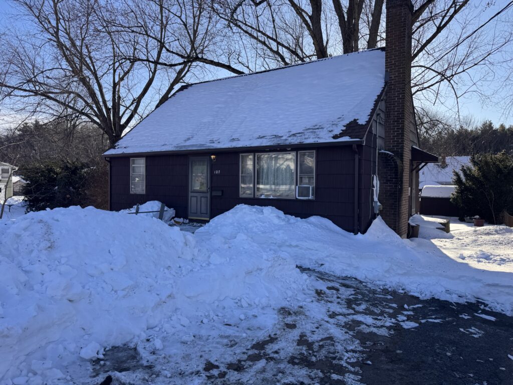 Before: original dark brown siding and dated windows, 127 Brook St, Bristol CT, winter 2026