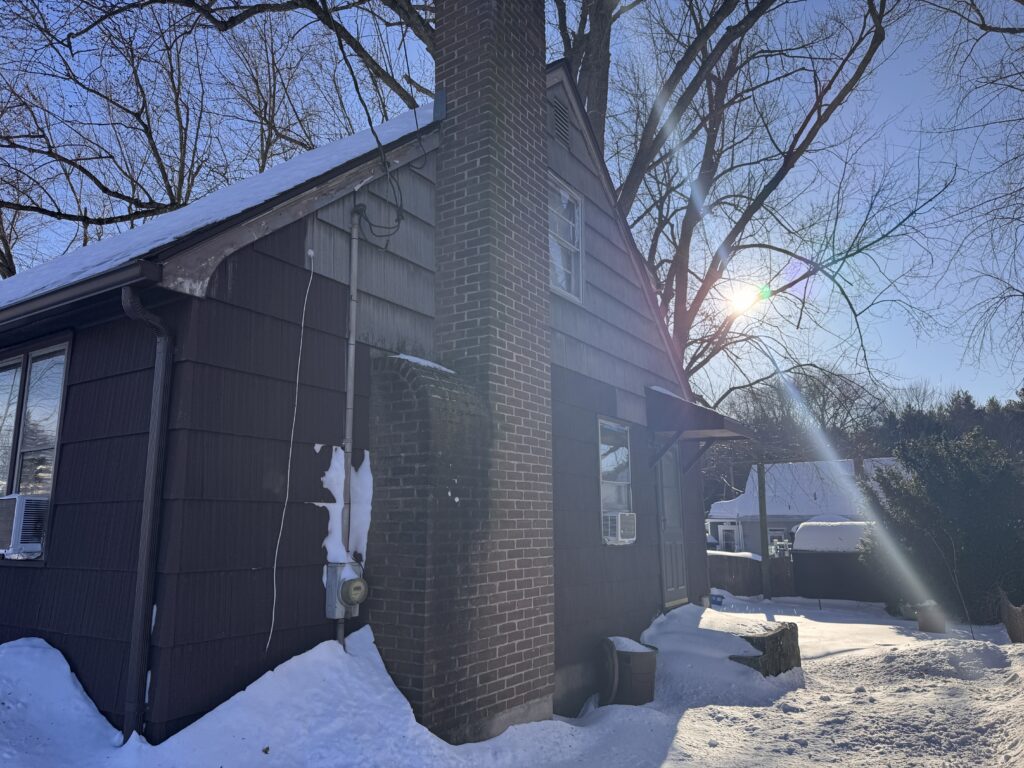 Before: original siding beside brick chimney, Bristol CT