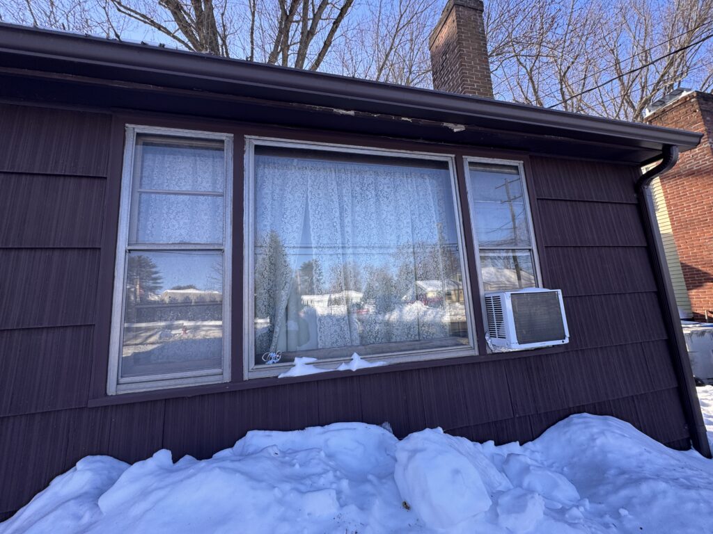 Before: original picture window with window AC unit and aged siding, Bristol CT