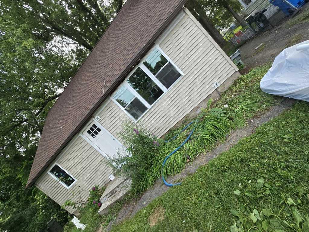 After: completed siding and window replacement, side view, Bristol CT